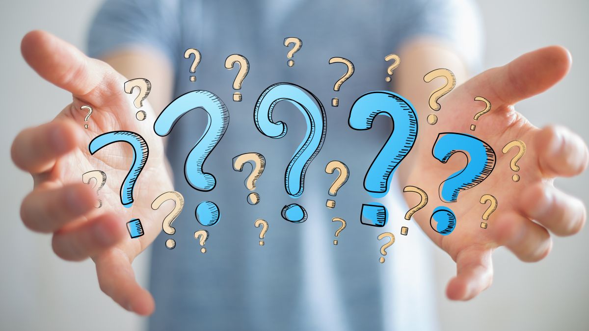 two hands juggling question marks