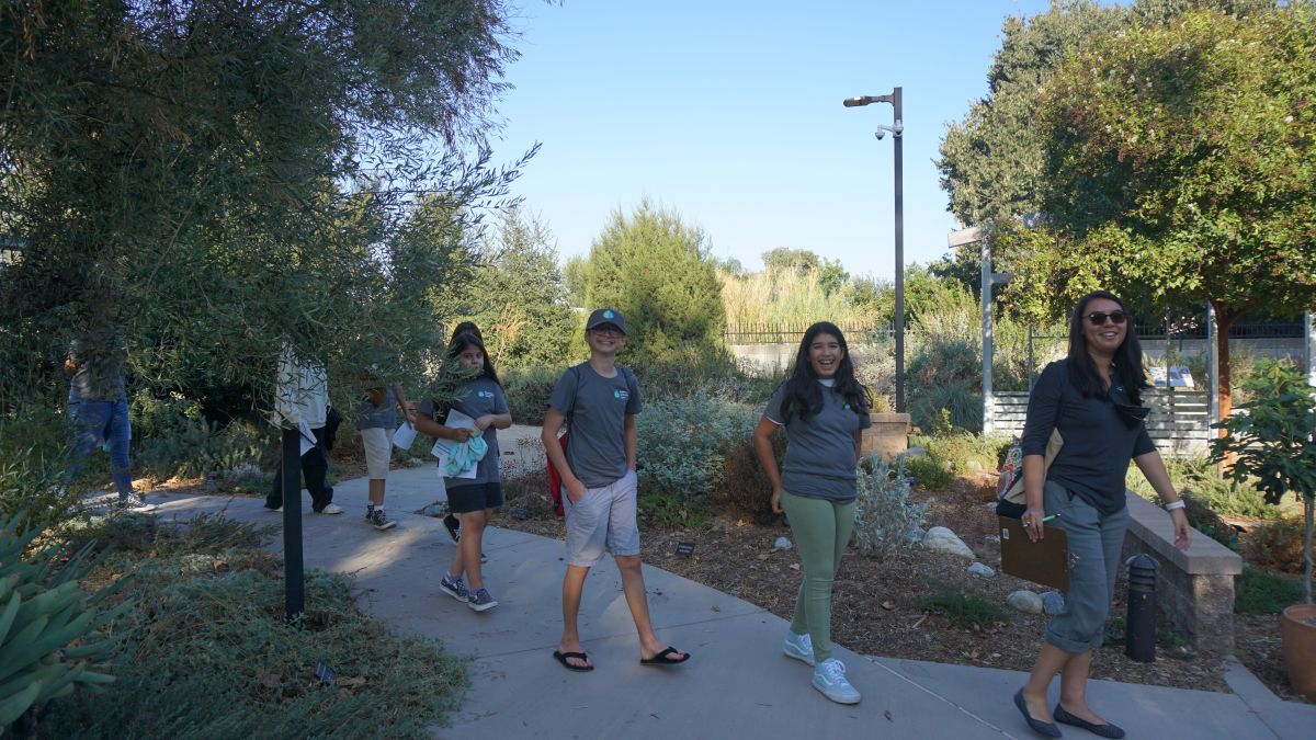 Group of people walking on a path outside