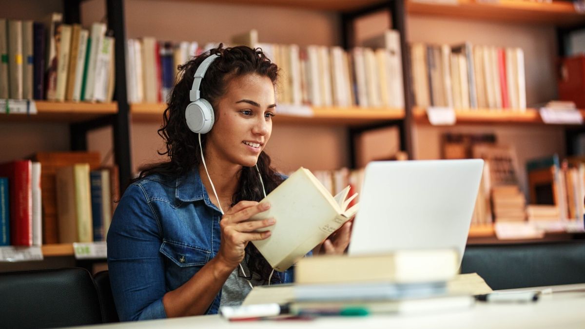 Woman studies in a library