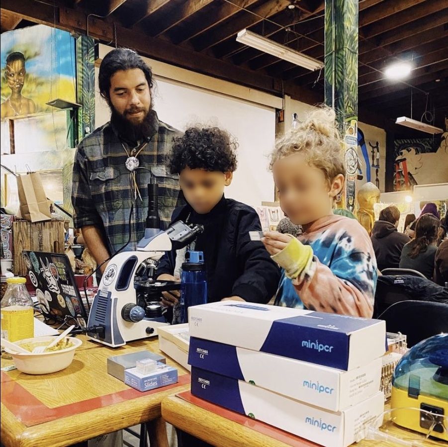 Jiapsi sharing microscope equipment with youth during the 2020 POC Fungi Community Gathering at the World Beat Center in San Diego,CA. 