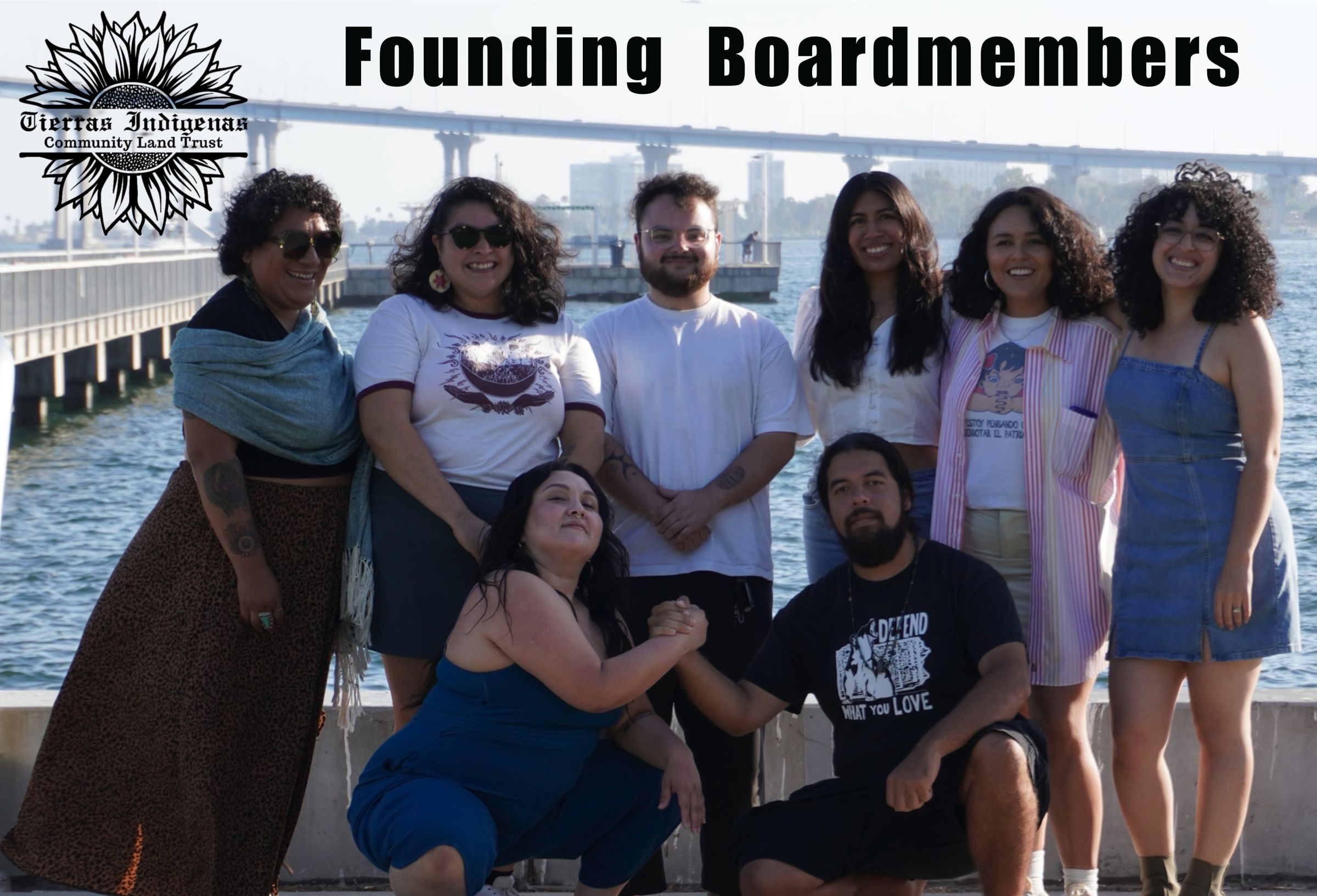 Jiapsi with his fellow foundering board members of the Tierras Indigenas Community Land Trust, wearing a shirt saying “Defend What You Love”.