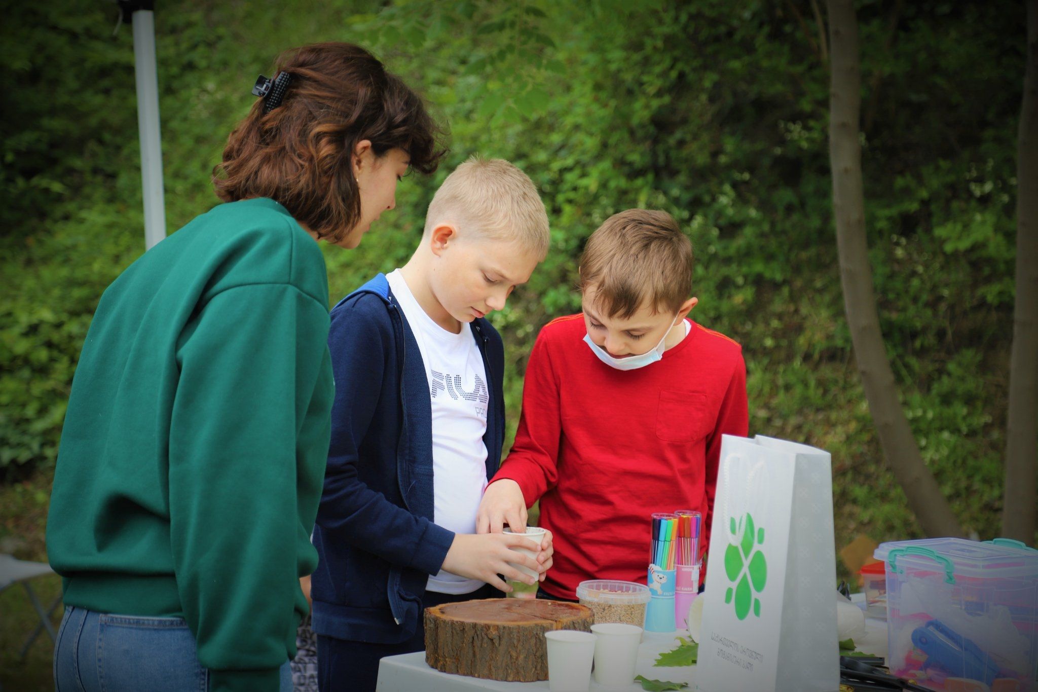 Kristine shows students how to plant seeds which is part of EE program