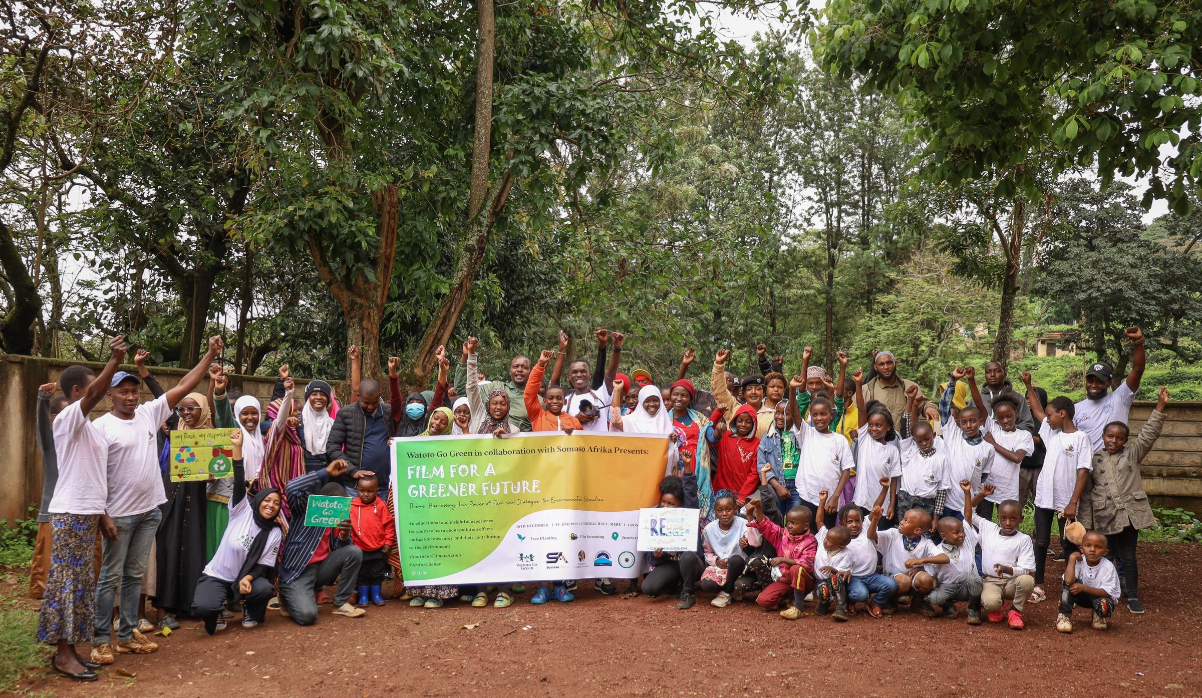 Nuria and her team take a photo with students during a tree planting activity at the local community.