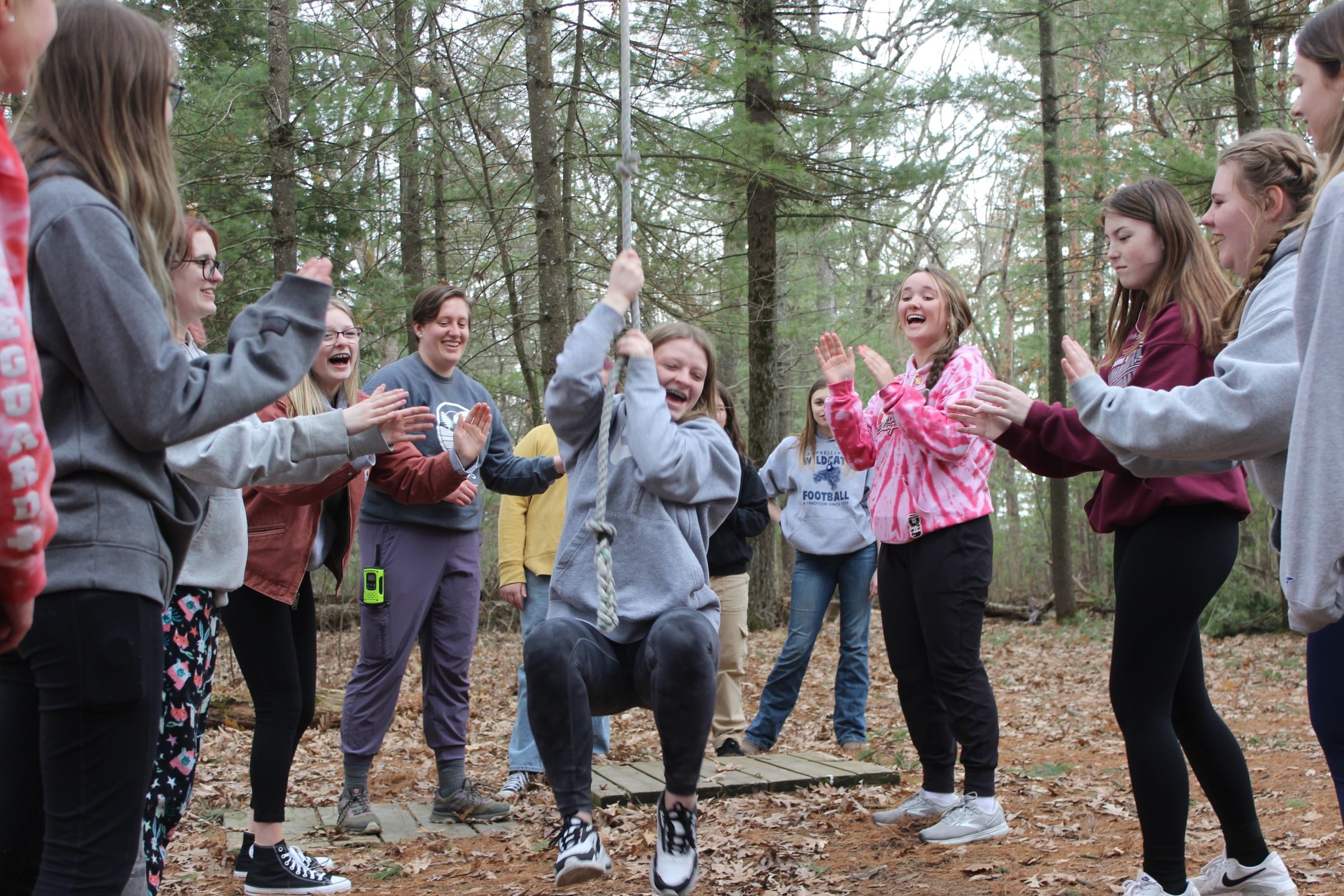 Rachael facilitates a low ropes challenge course during a spring youth leadership day. 