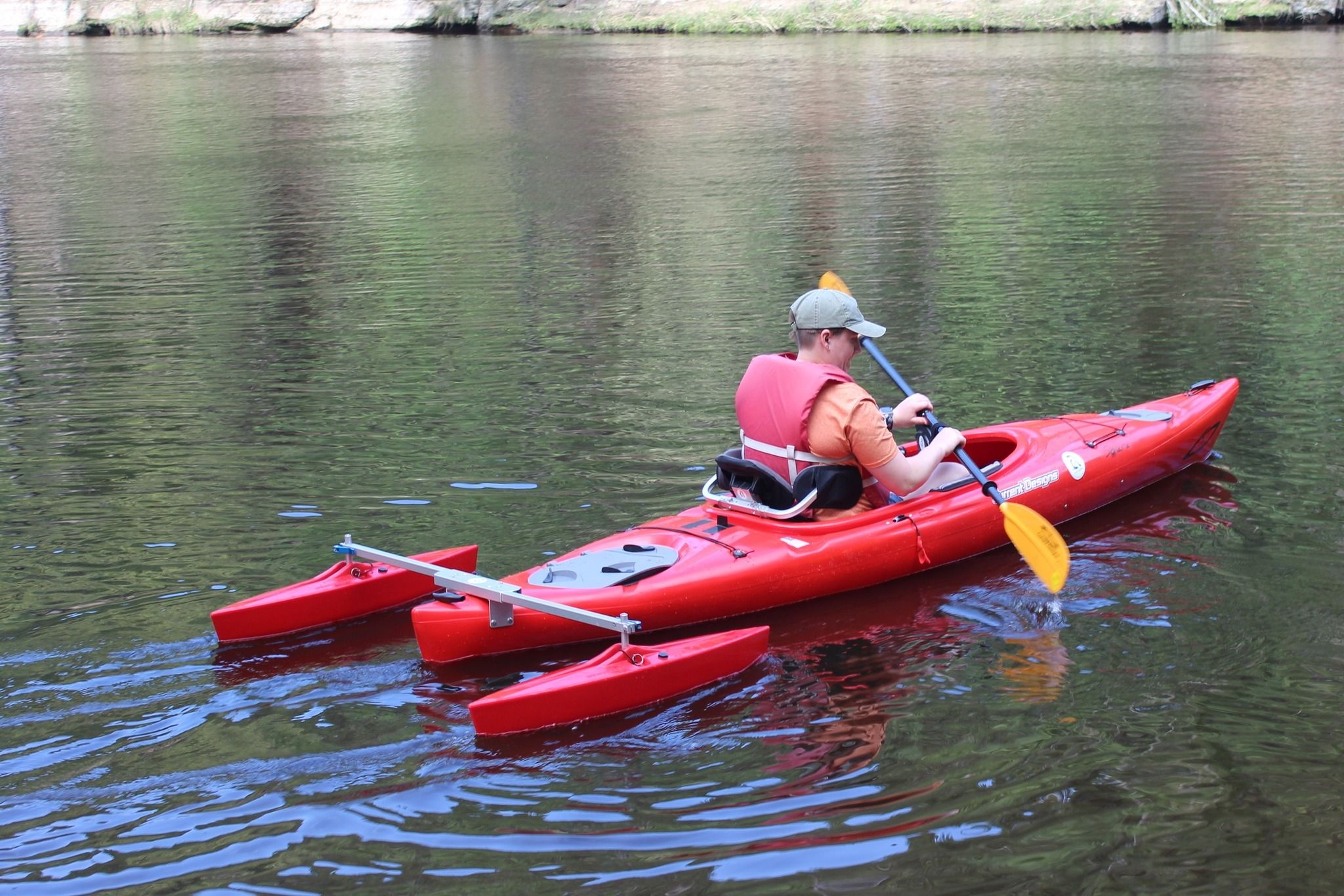 : Rachael trains staff  on how to use an adaptive kayak with outriggers and a paddle pivot during an in-service day.