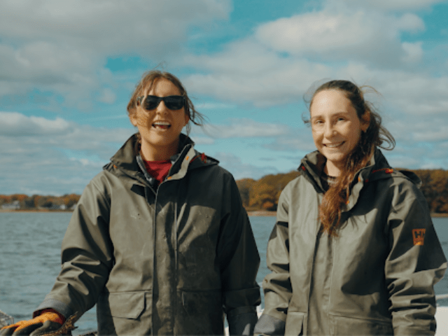 Two sisters on a boat in the ocean