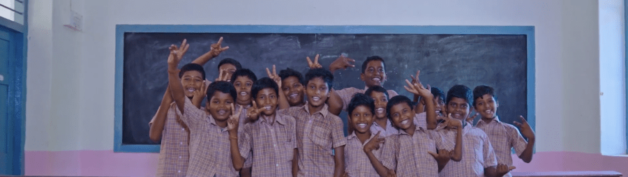 Children are excited in a classroom. 
