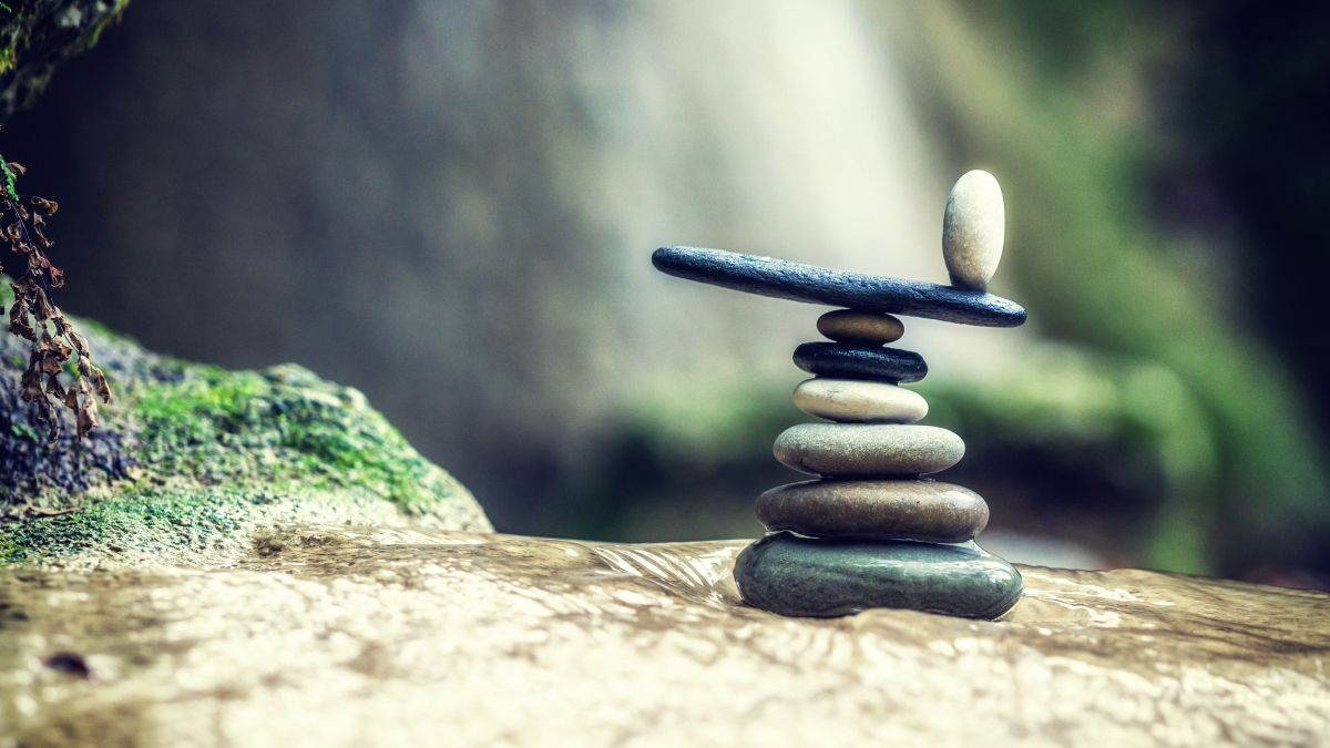 Balanced Rock Zen Stack in front of waterfall