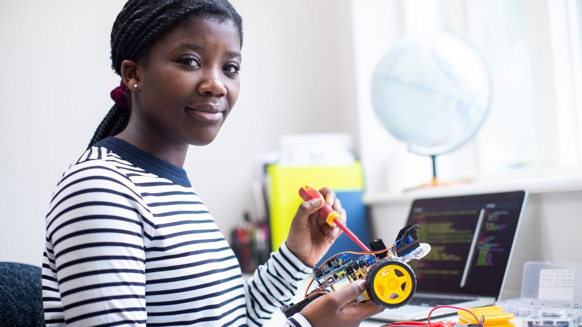 teen working on robotics project at desk