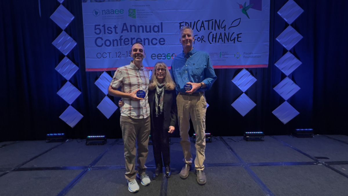 Professors Bob Powell and Marc Stern receive the Outstanding Contributions to Environmental Education Research Award from Executive Director Judy Braus at the 2022 NAAEE Annual Research Symposium in Tucson, Arizona.