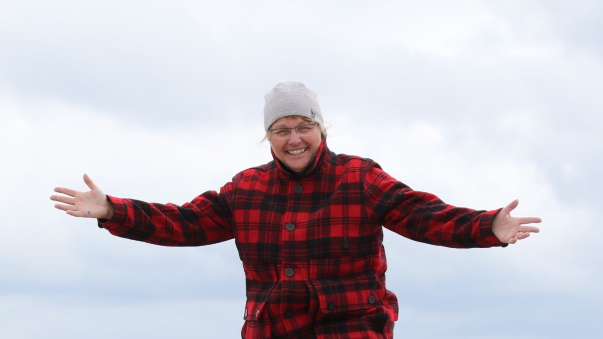 Photo of Heidi McAllister on a boulder