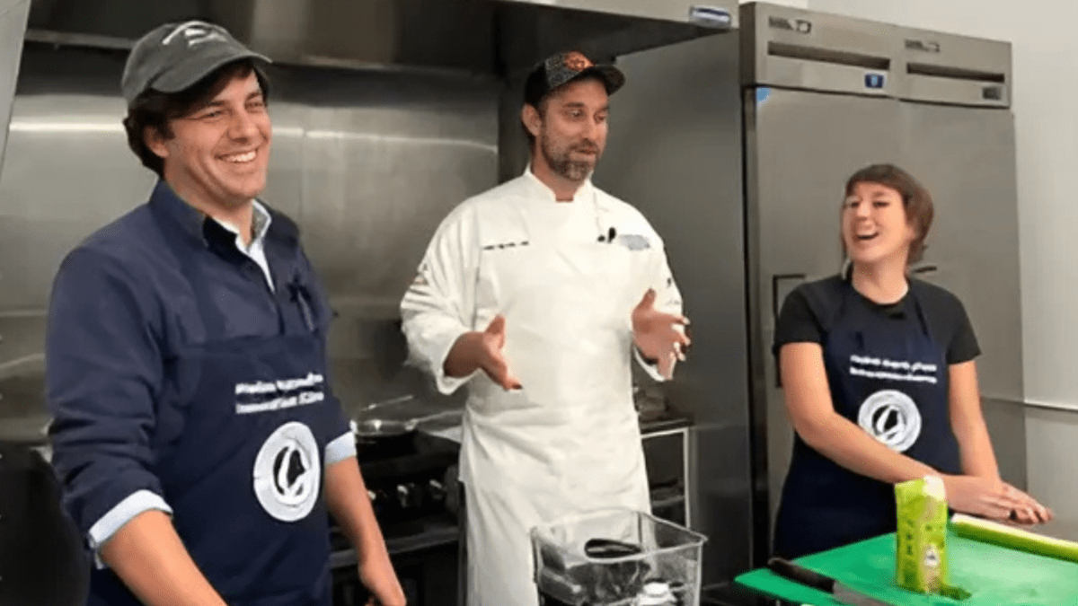 Three people inside a kitchen