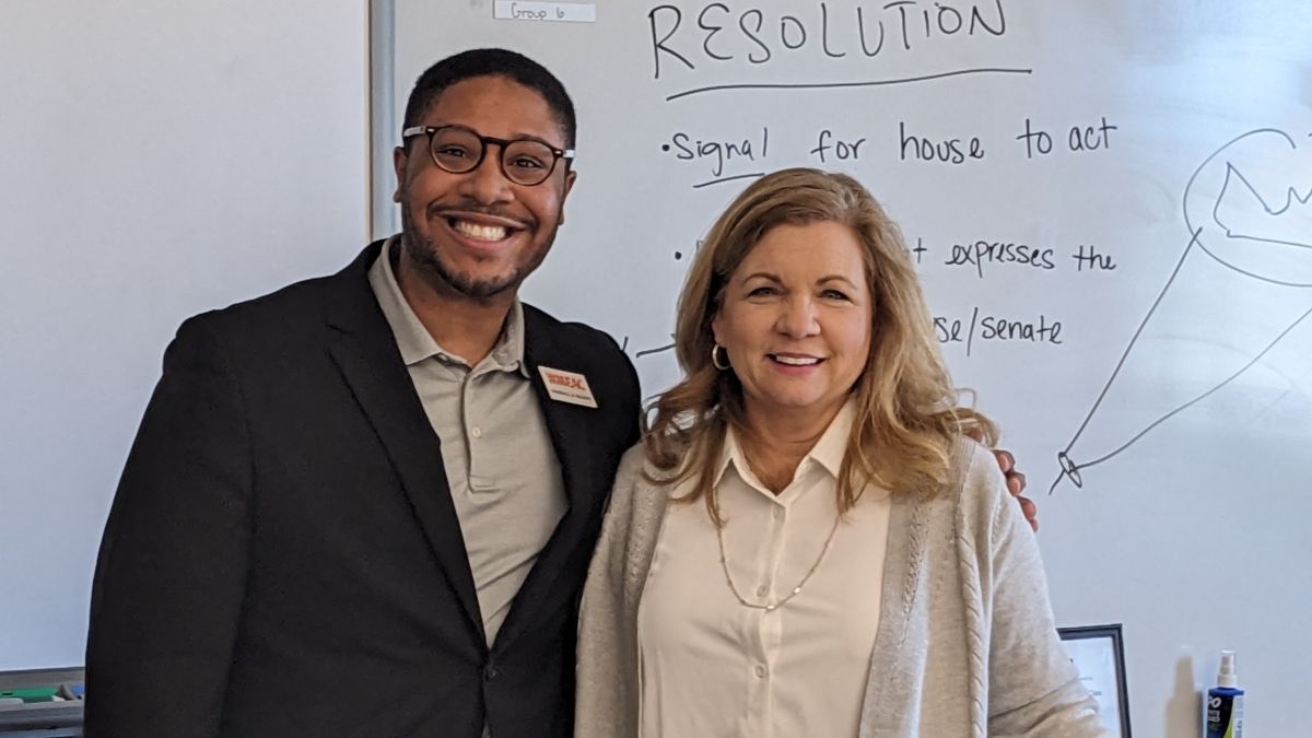 Patty Tolly standing with a visiting speaker in her classroom