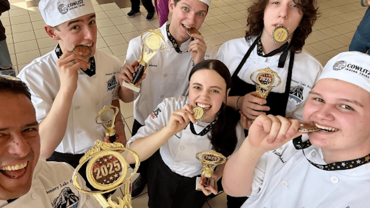 High school culinary students celebrate with award medals