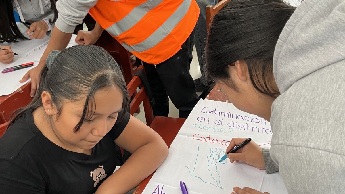 two girls working on a large poster