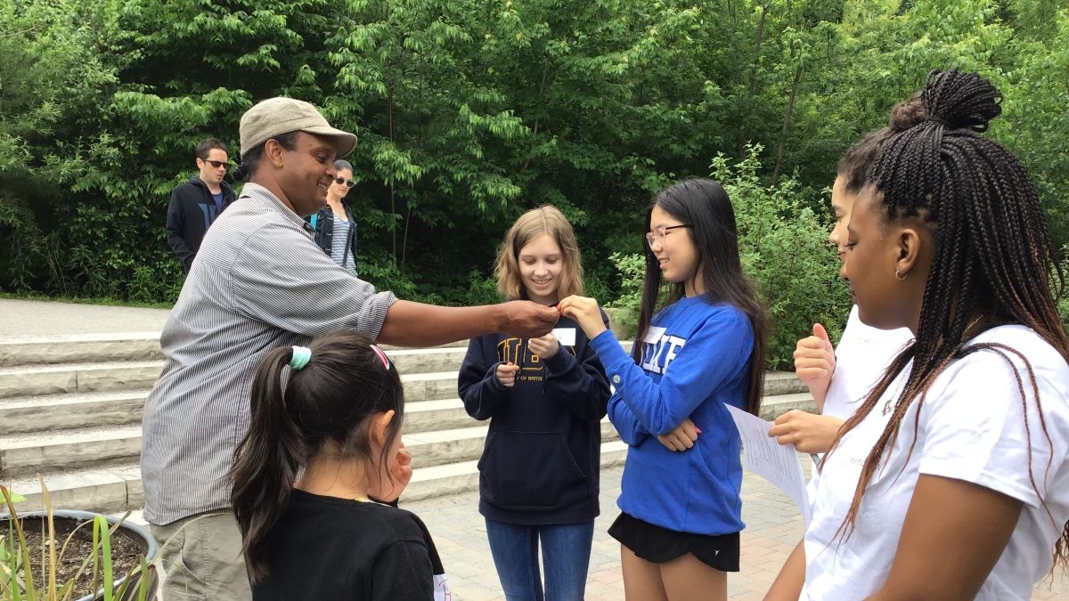 naturalist handing children something to look at