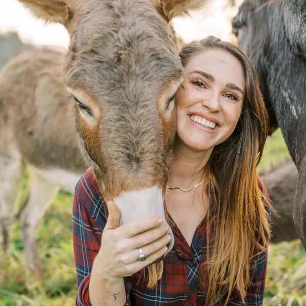 CEE Change Fellow Katie Russell hugging a donkey