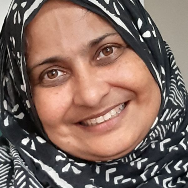 CEE change Fellow Aneesa Jamal wearing a black and white scarf