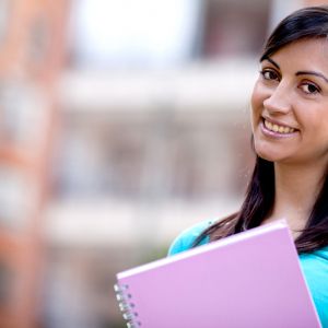 Woman smiling holding notebook