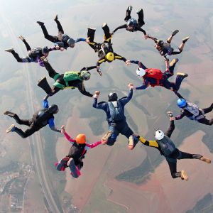 group of people forming a net while skydiving 