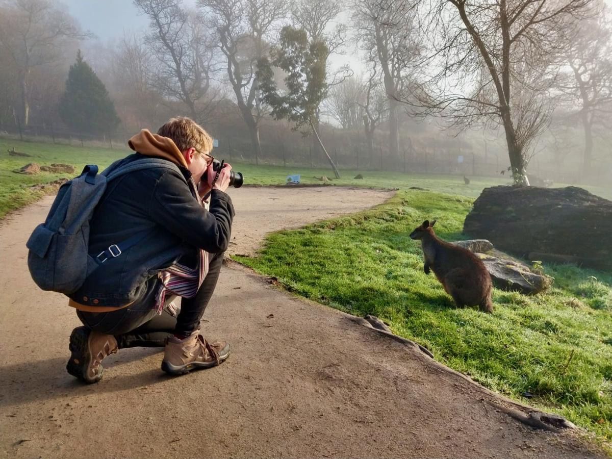 Jack Baker taking a picture of a pangolin