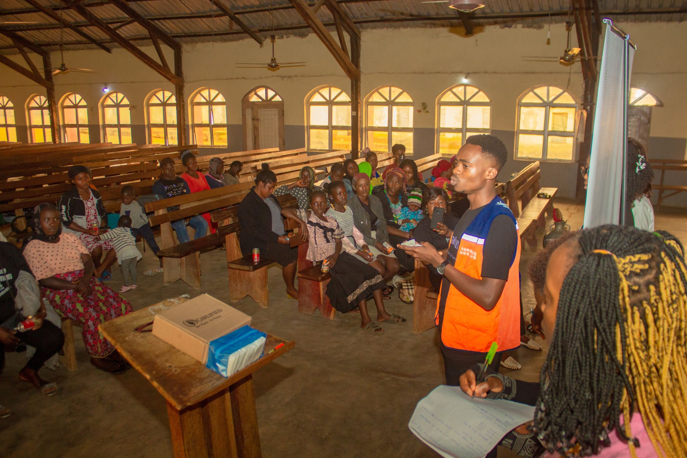 Oghenekevwe educating women and girls at Rankyeng, Jos Nigeria on plastic pollution from sanitary pad usage, promoting eco-friendly sanitary pad Girlified which he founded.