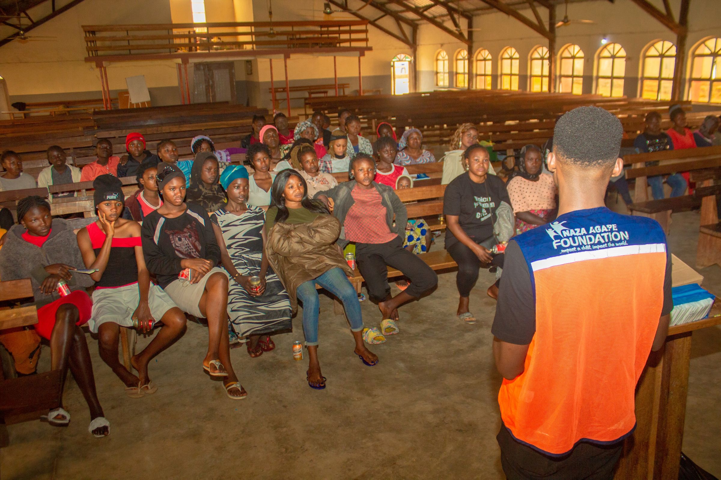 Oghenekevwe educating women and girls at Rankyeng, Jos Nigeria on plastic pollution from sanitary pad usage, promoting eco-friendly sanitary pad Girlified which he founded.