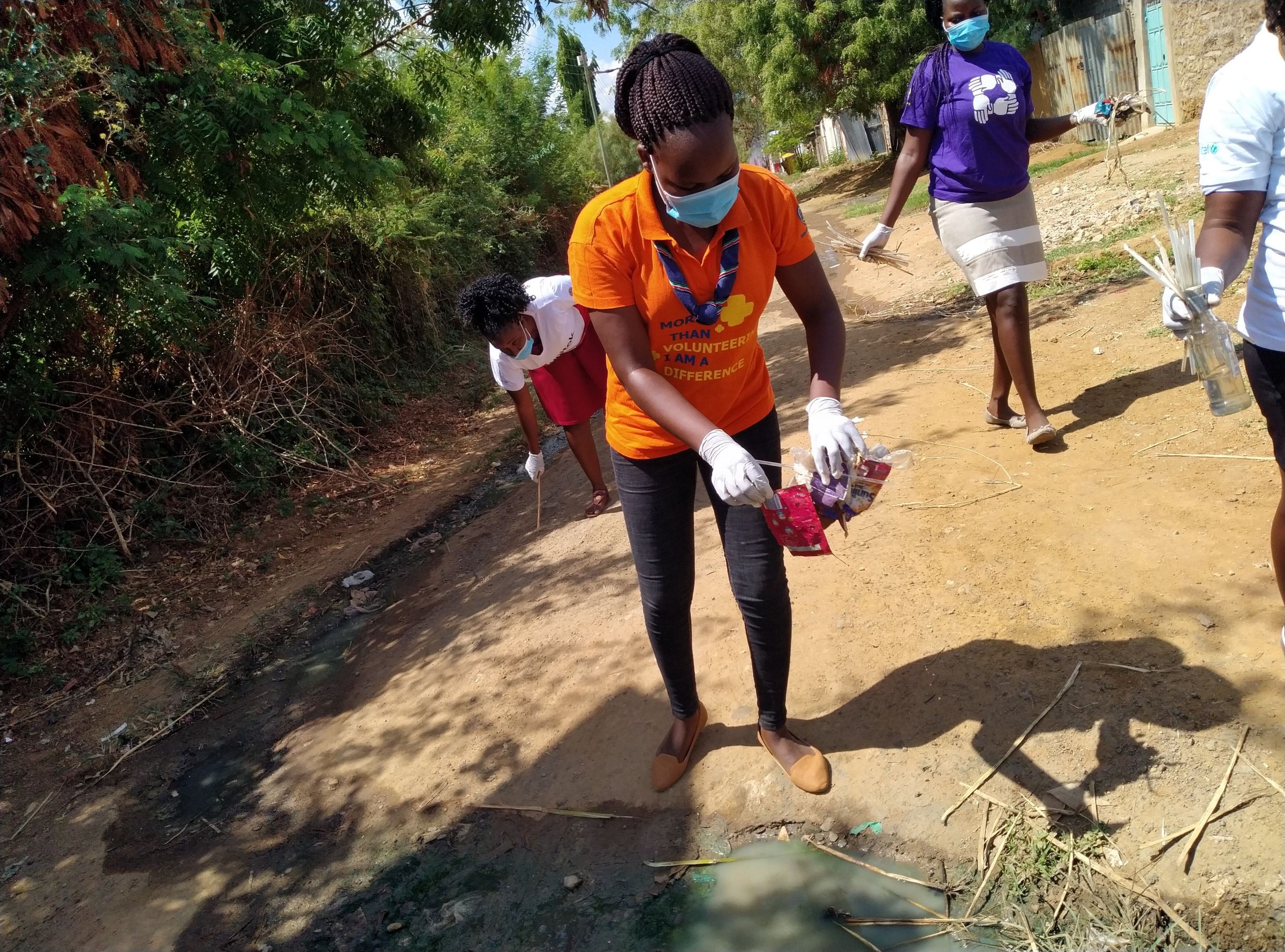 Collecting plastic waste during a clean-up activity in Tharaka-Nithi County. Credit: Innocentia Nthiga, Kenya Girl Guides Association.