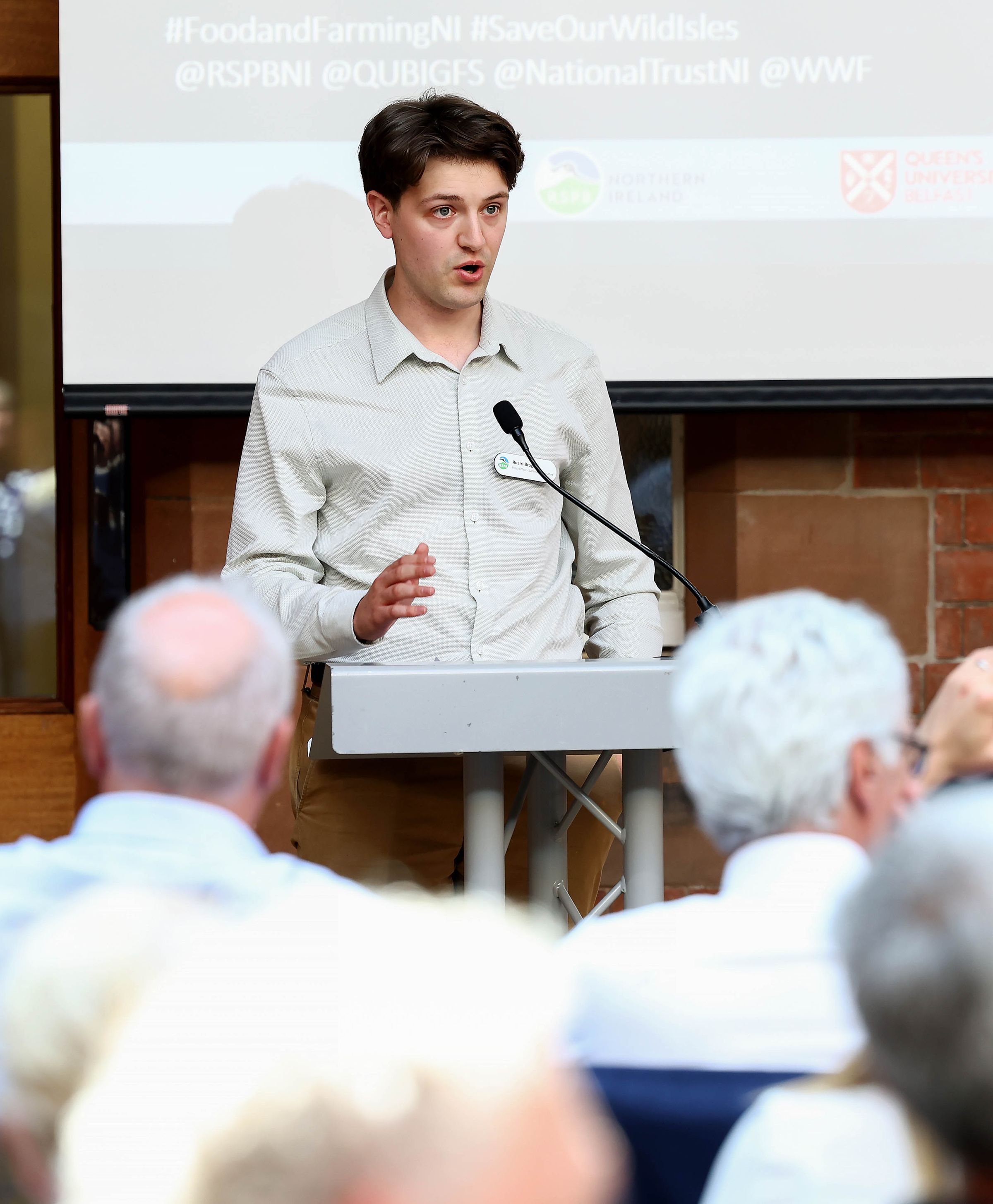 Ruairi presenting a nature friendly farming project at the “Save Our Wild Isles Northern Ireland“ Food and Farming Conference, Queen’s University Belfast. Credit: Press Eye. 