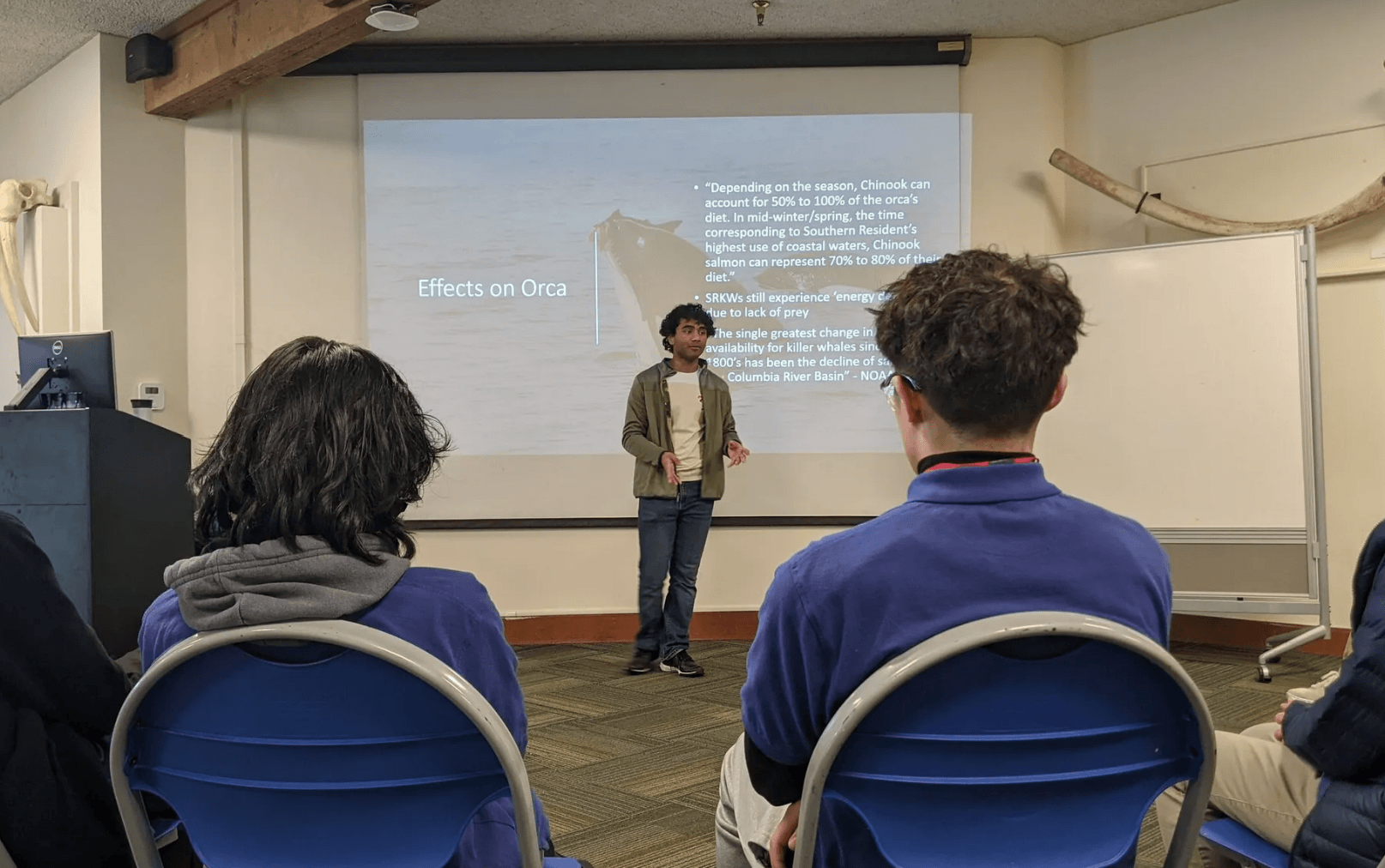 Maanit educating youth volunteers at the Seattle Aquarium about salmon and orca decline factors. Credit: Jenn Smith.