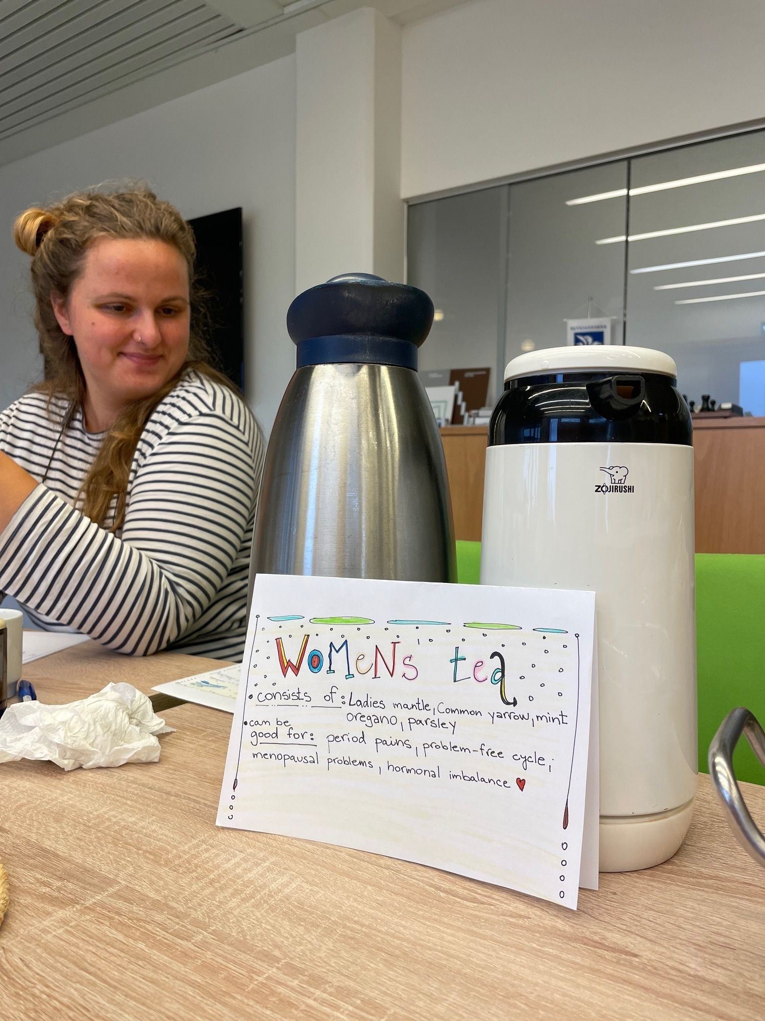 Katka sitting in a (handpicked) herbal tea stand, on a community action after their first community garden harvest in Iceland.