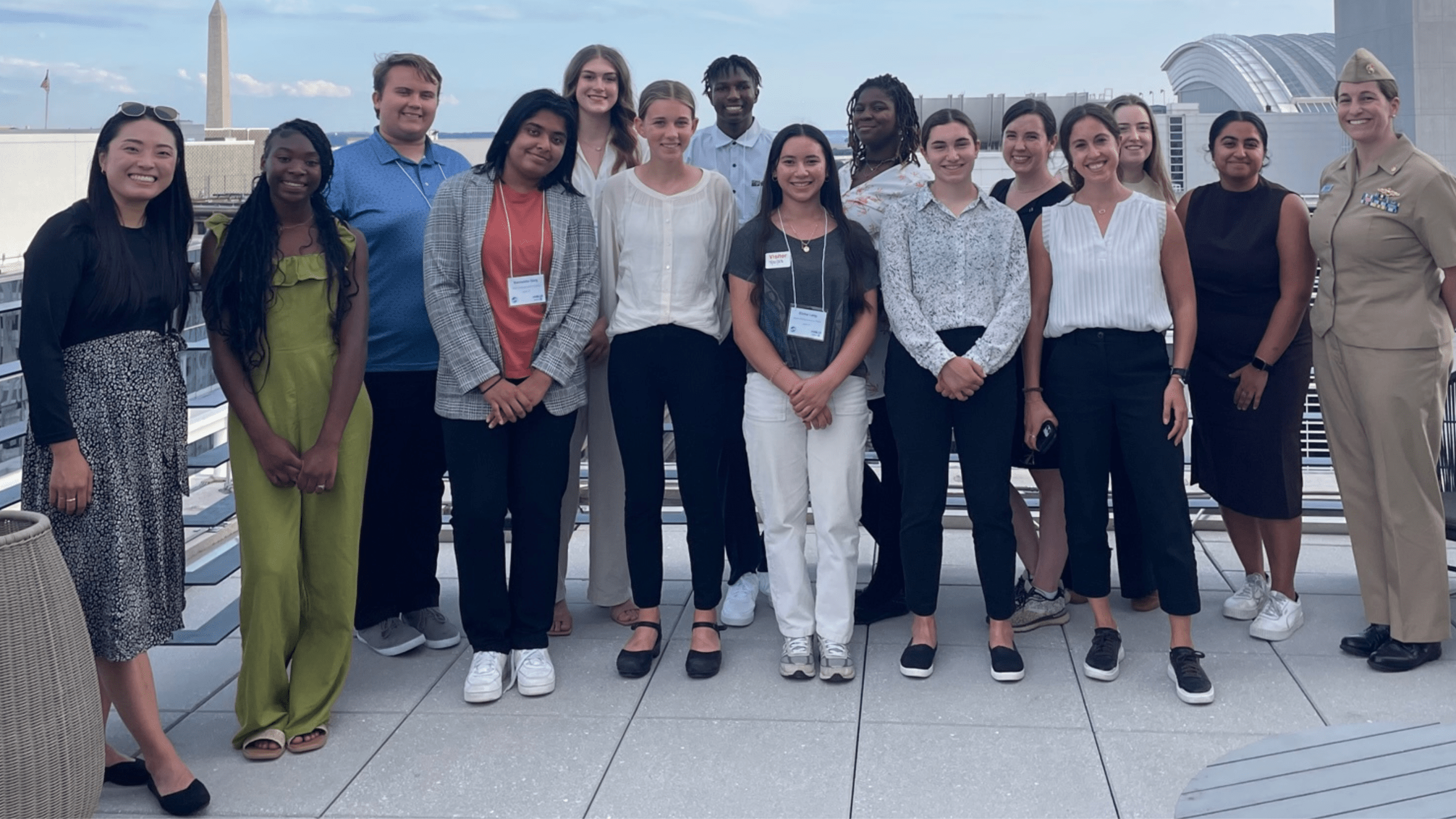 Group of 2023 eeBLUE Young Changemakers Fellows stand for a group photo outside on a balcony