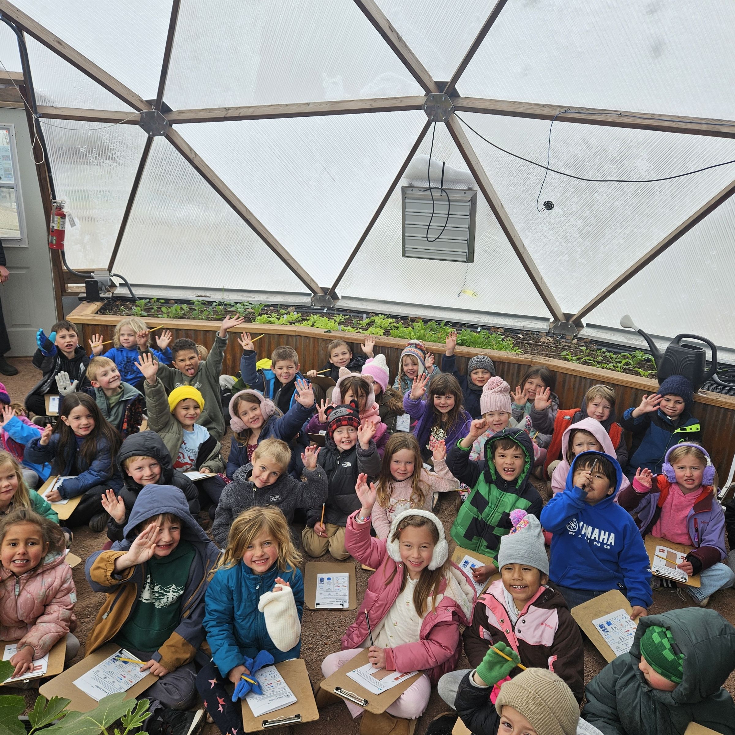 Group of kids inside a climate-protected grow dome