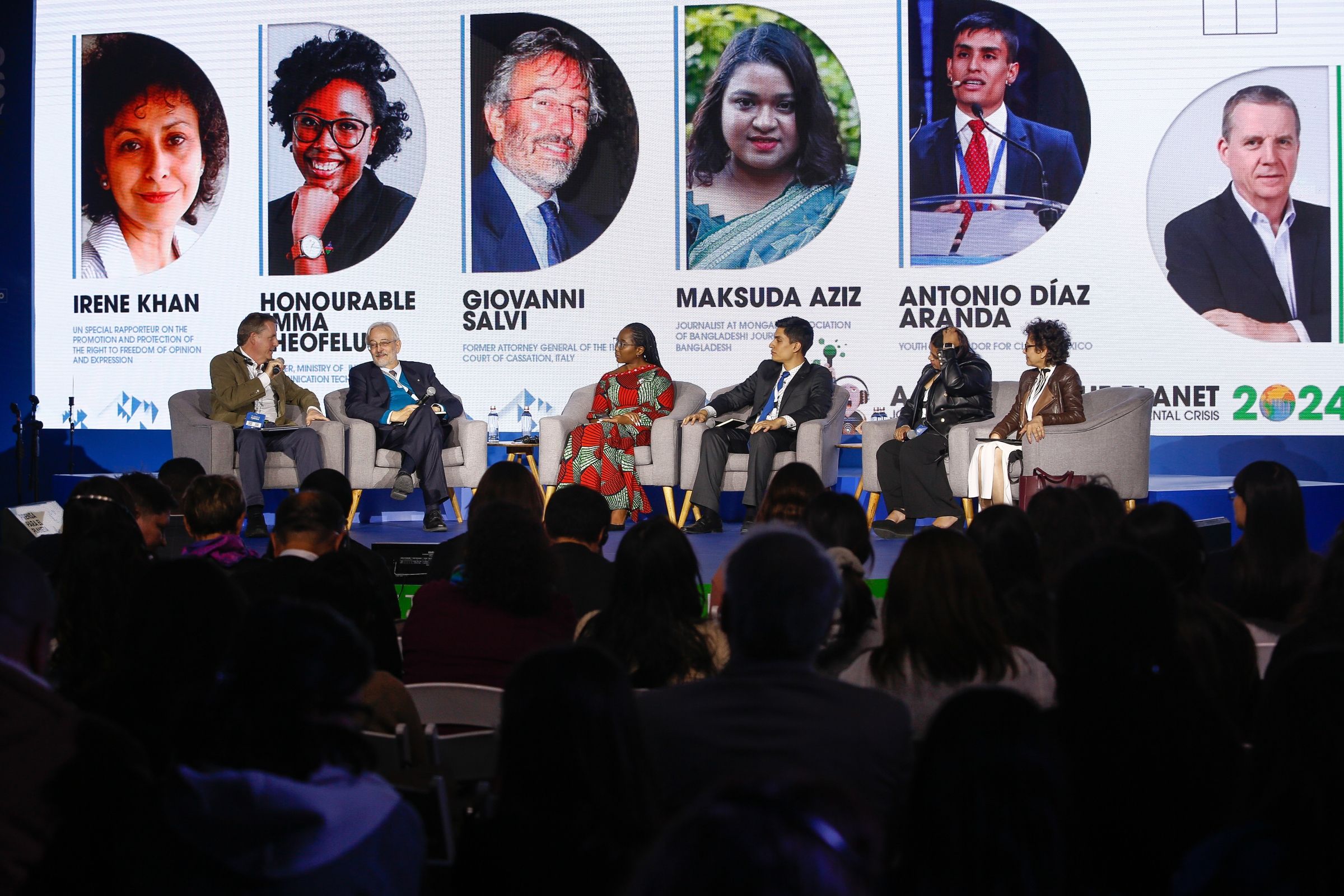 Six people sitting on a stage having a panel discussion