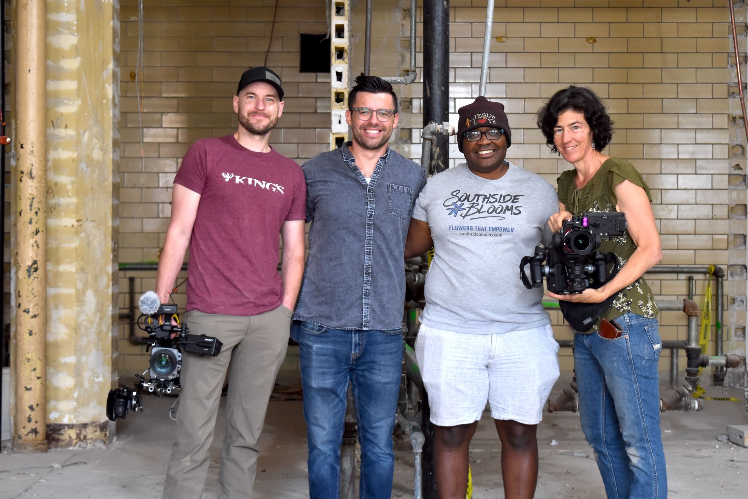 James Parker and Juliet Grable and two participants stand together while working on the In Our Nature documentary