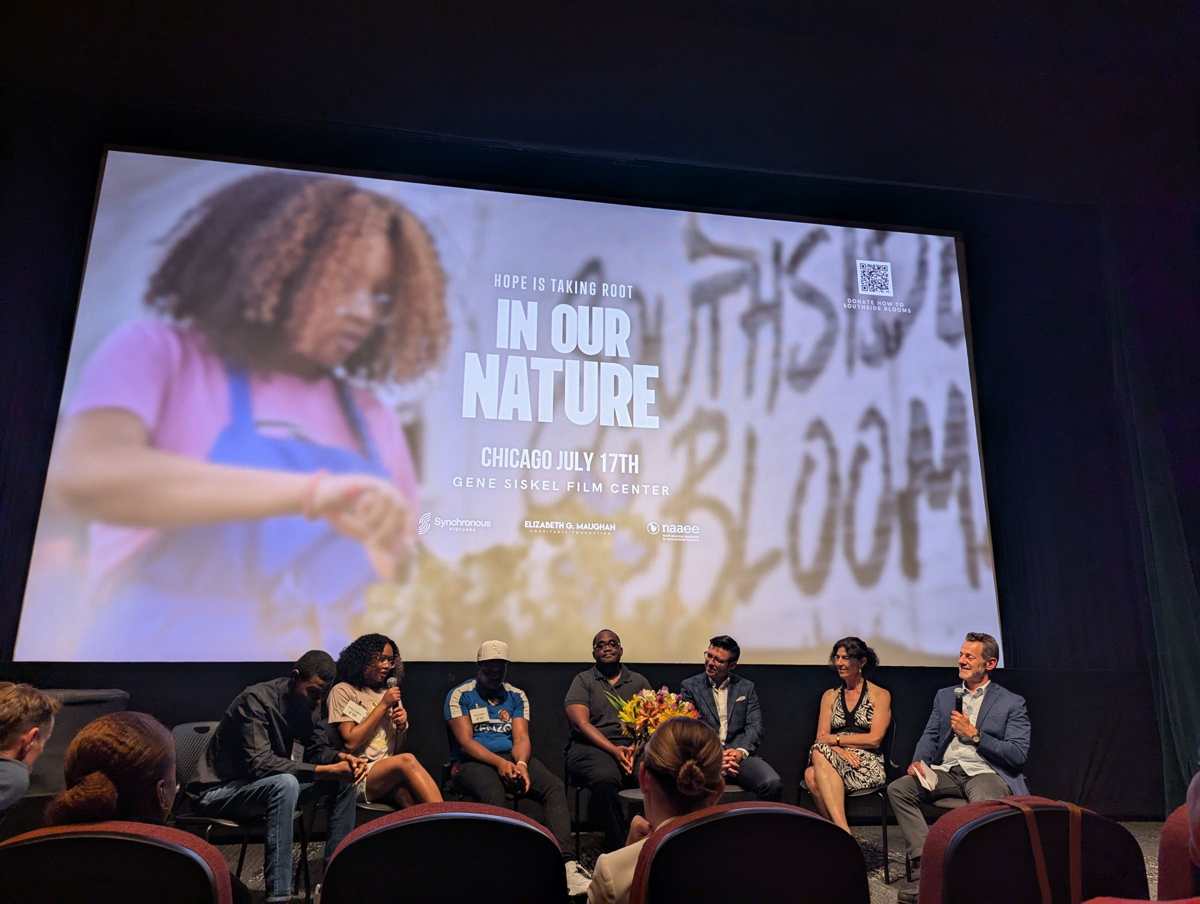 A panel of participants discusses onstage the film In Our Nature