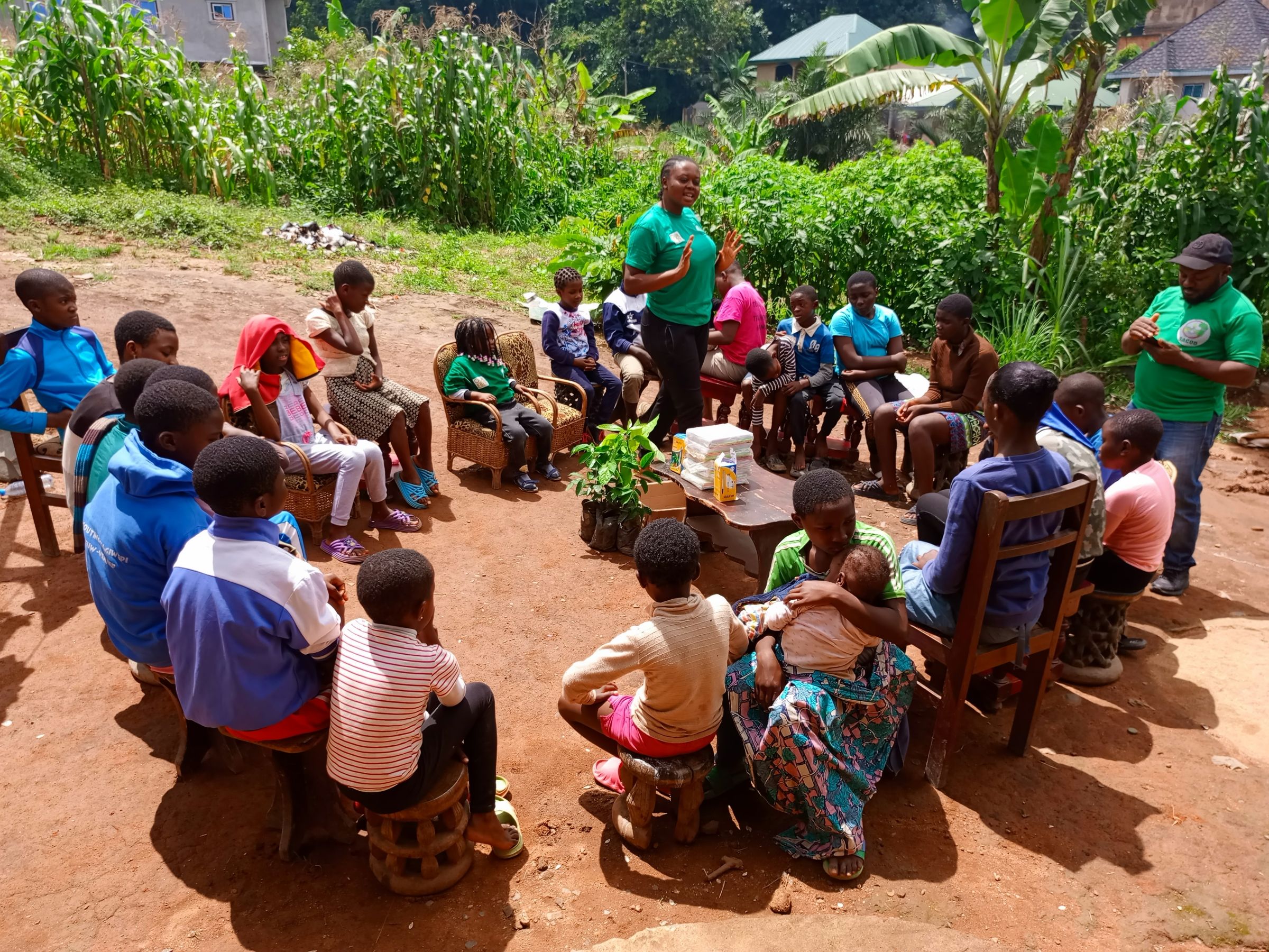 A large group of people sitting in a circle outdoors.