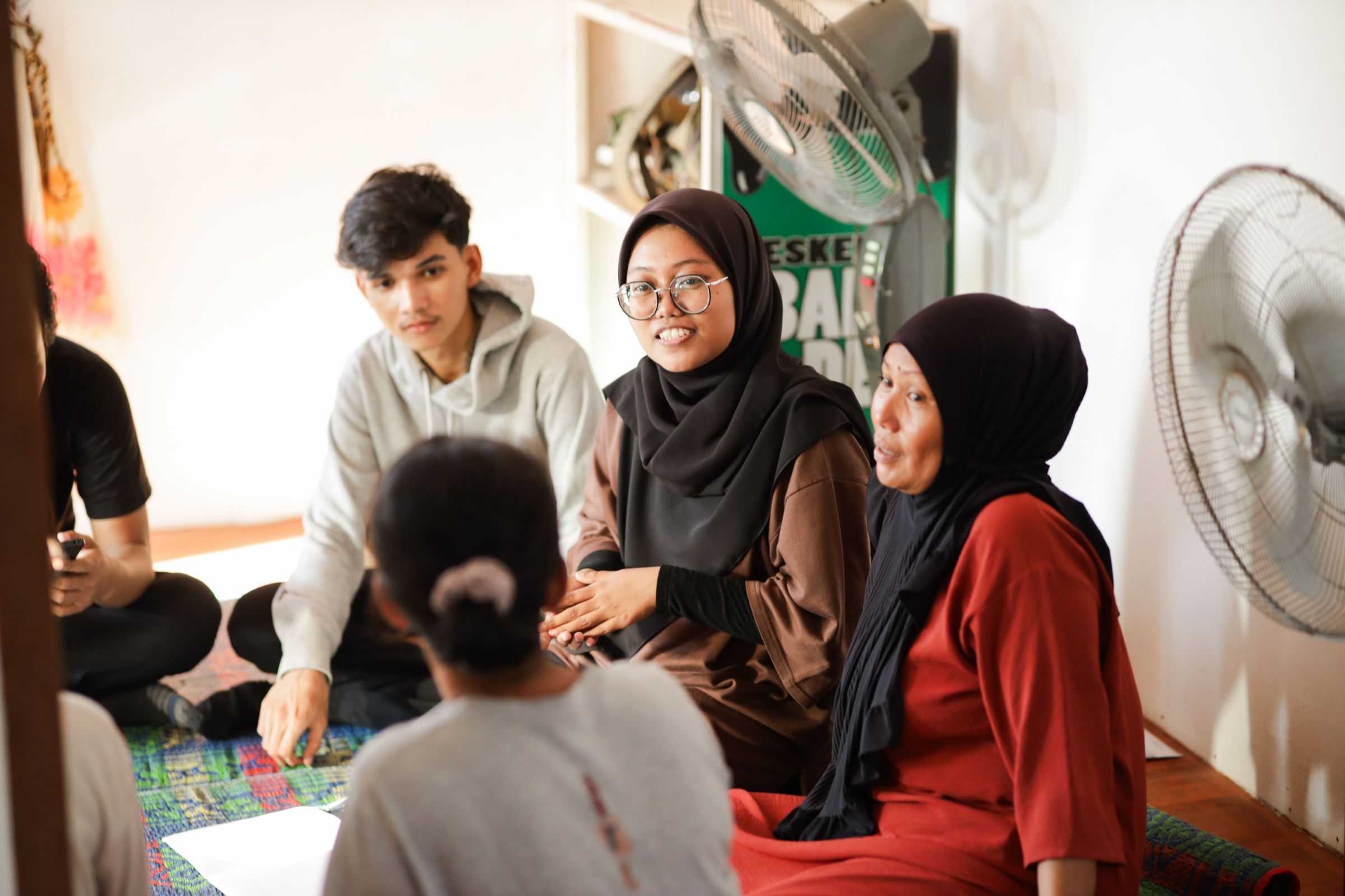 A group of young people sitting in a circle.