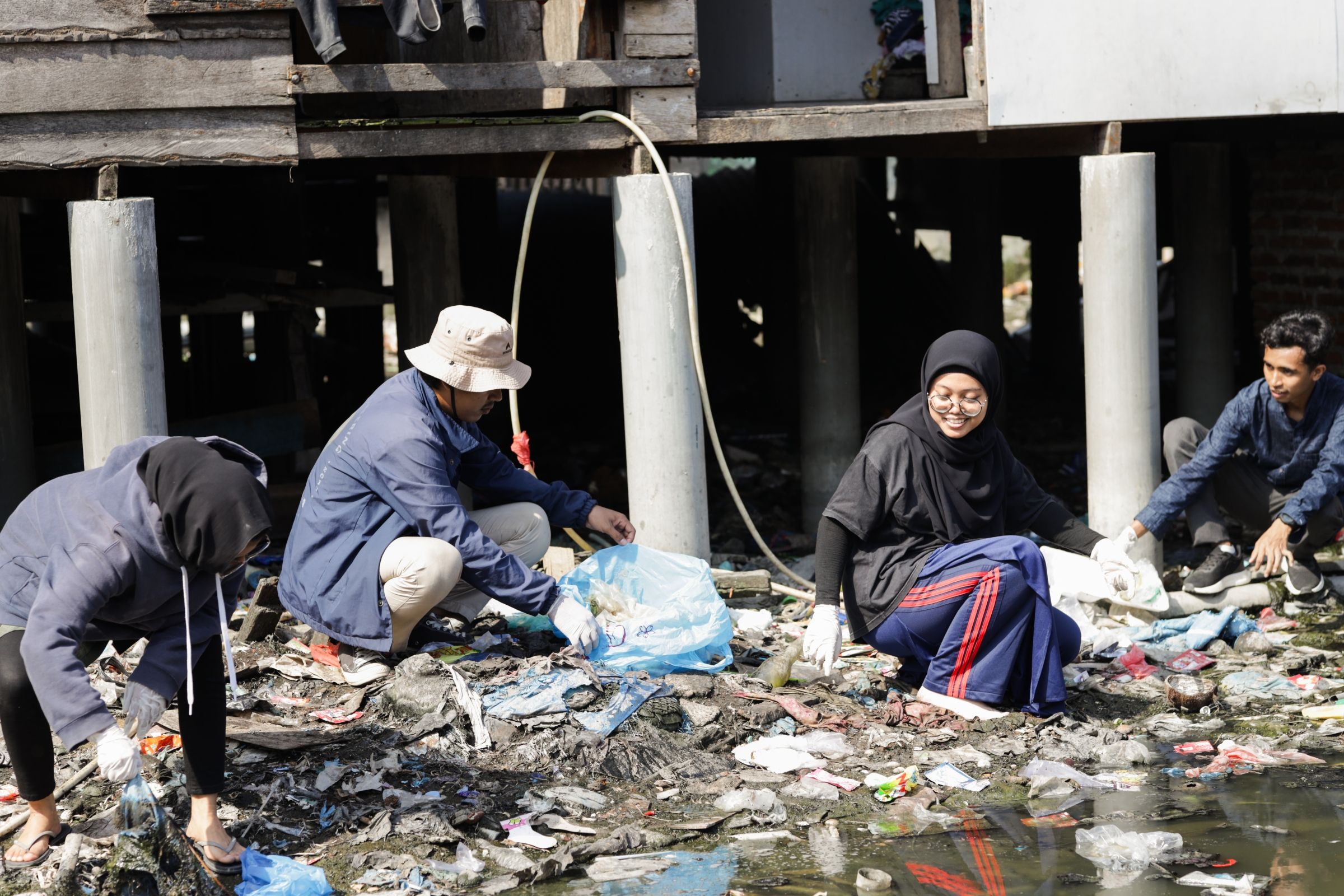 A group of people sampling wastewater.