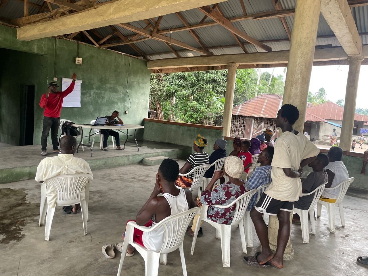 A person teaching at the front of a classroom.