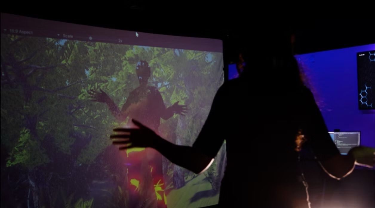 A woman standing and looking at a digital exhibition. 