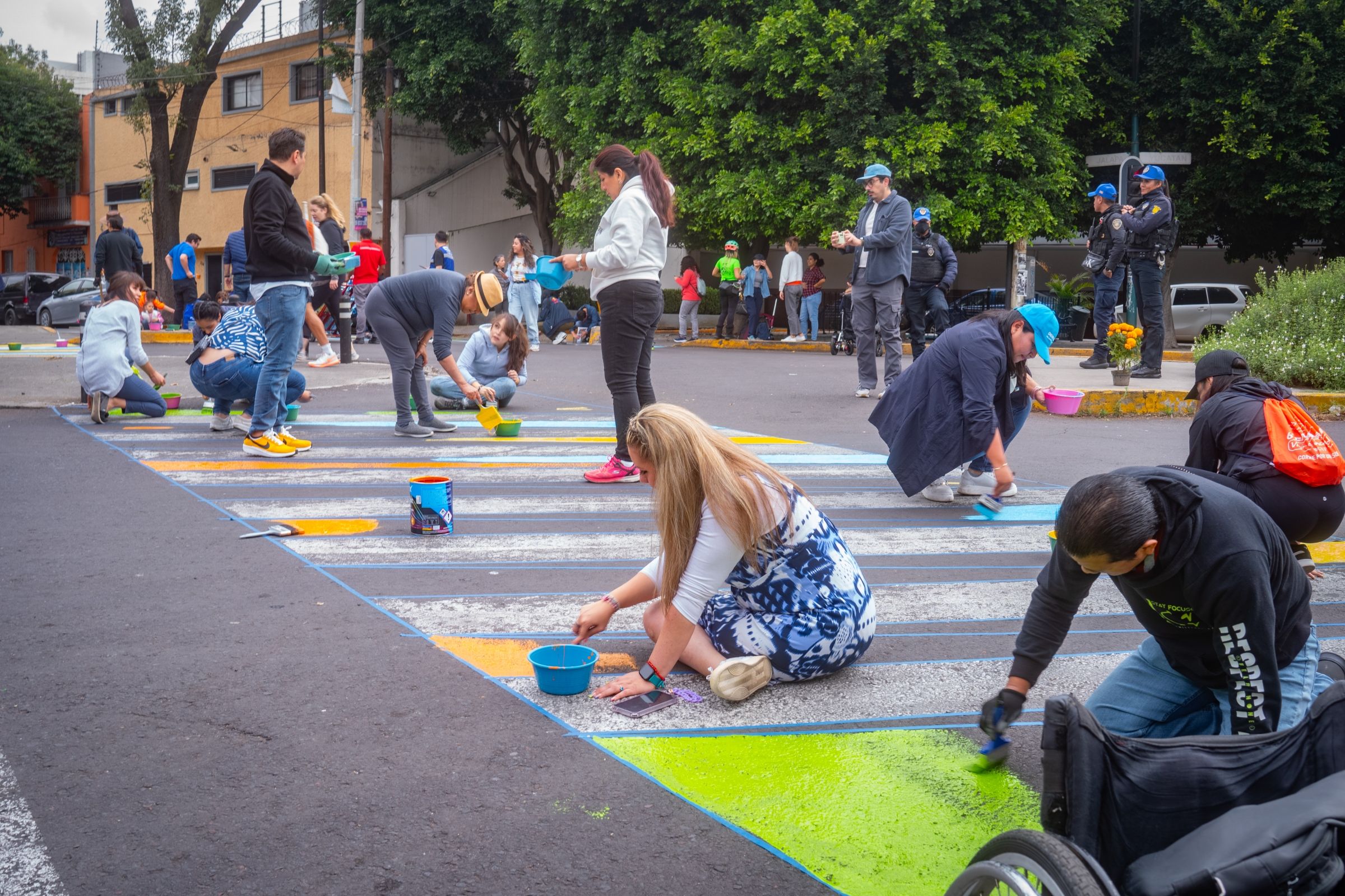 A group of people painting a crosswalk.