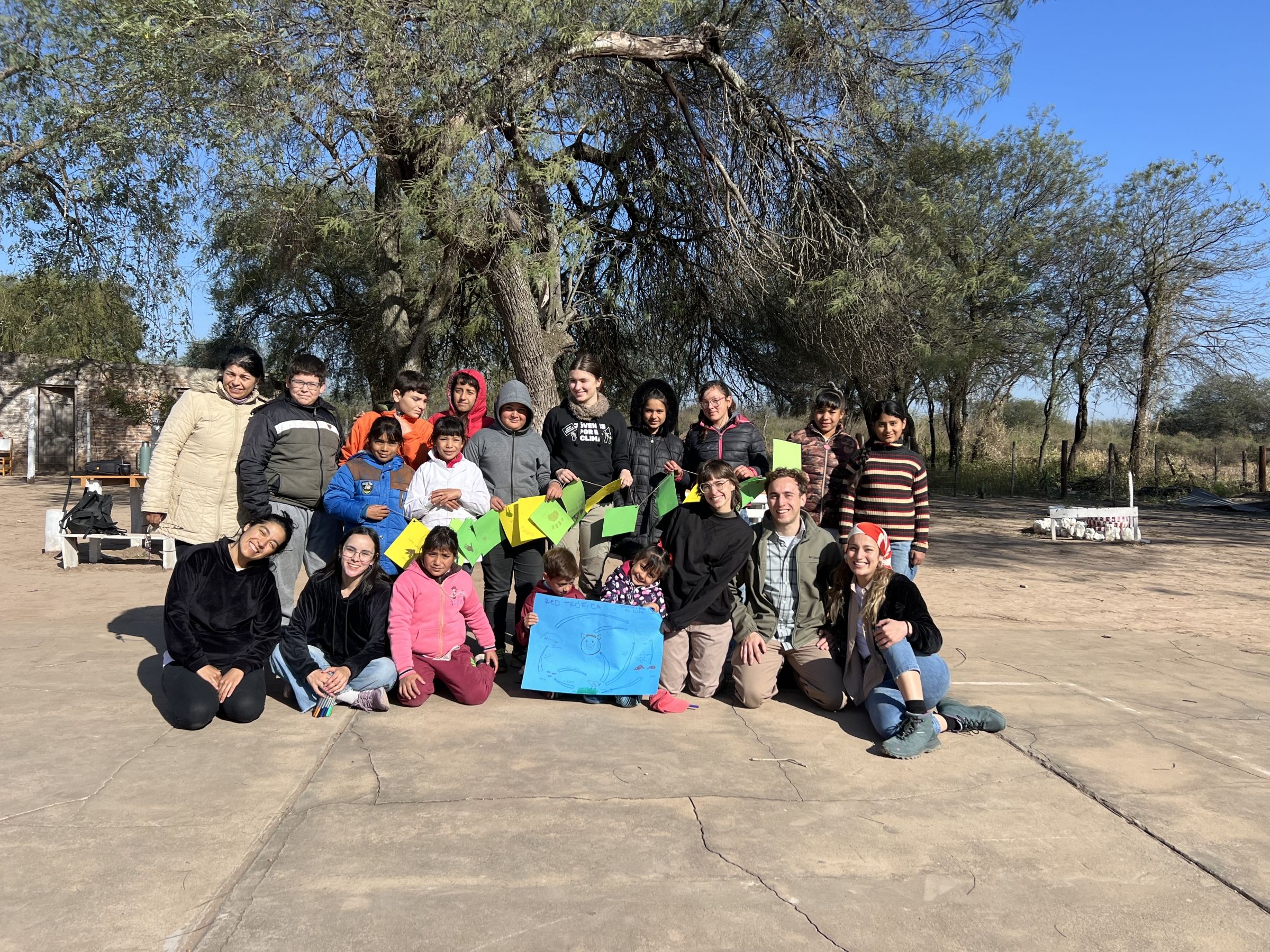 A group of children posing outdoors. 