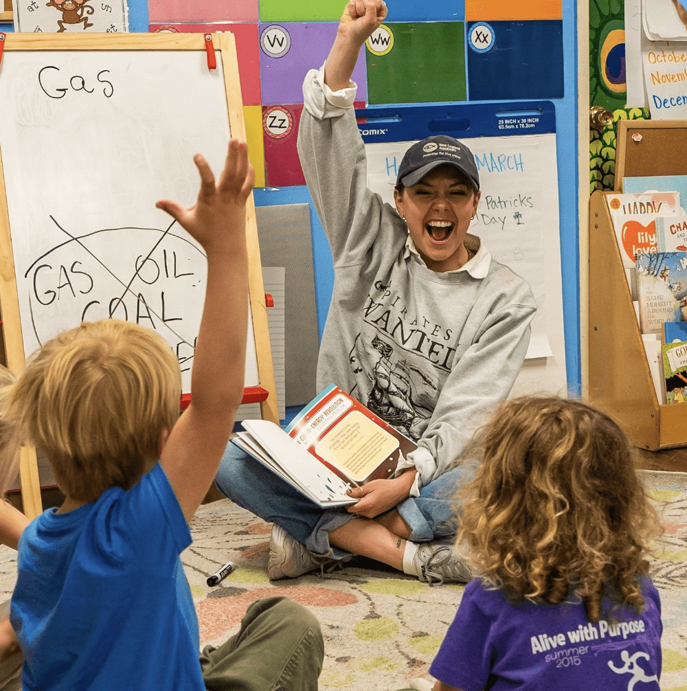 A person reading to children.
