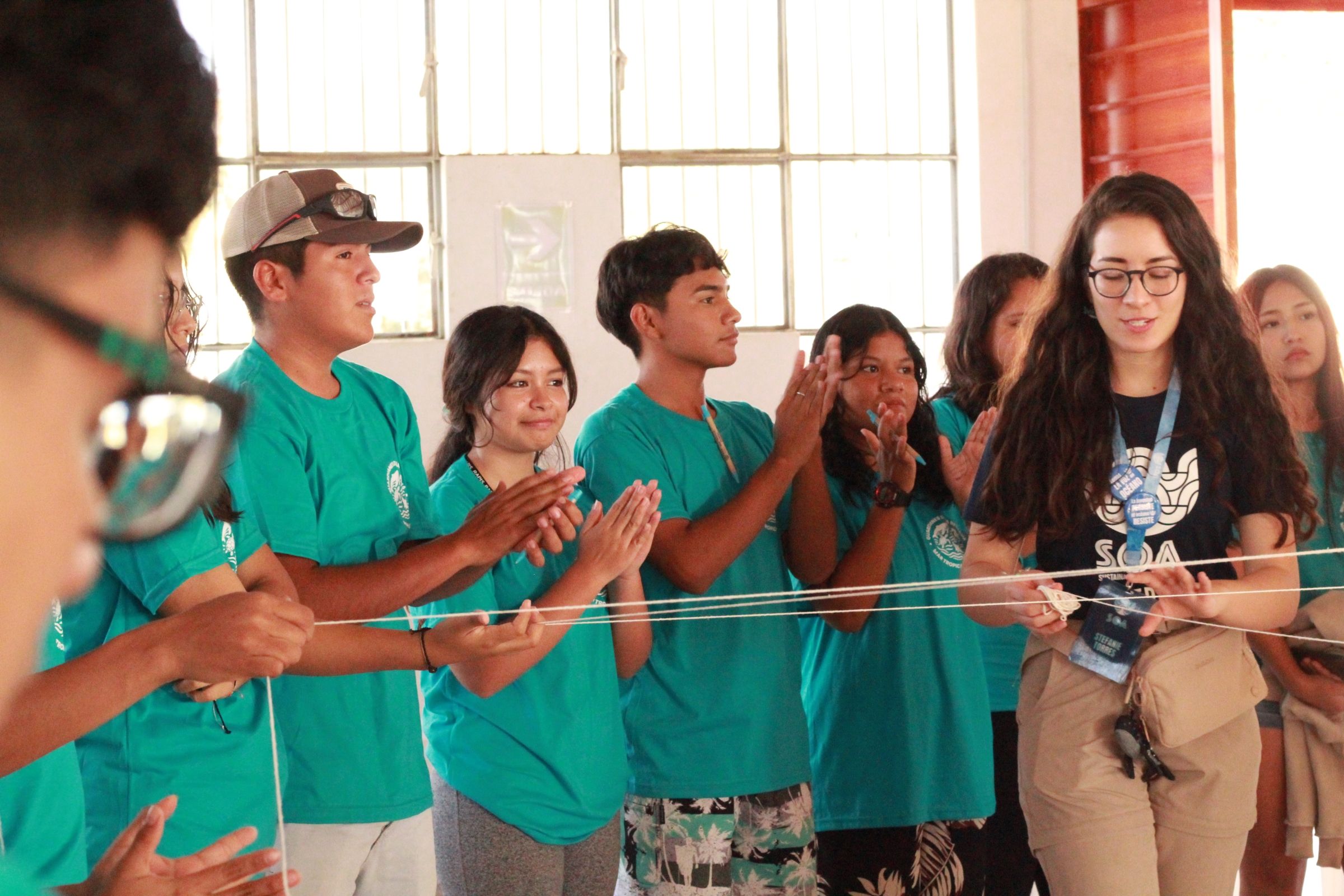 A woman working on an activity with students.